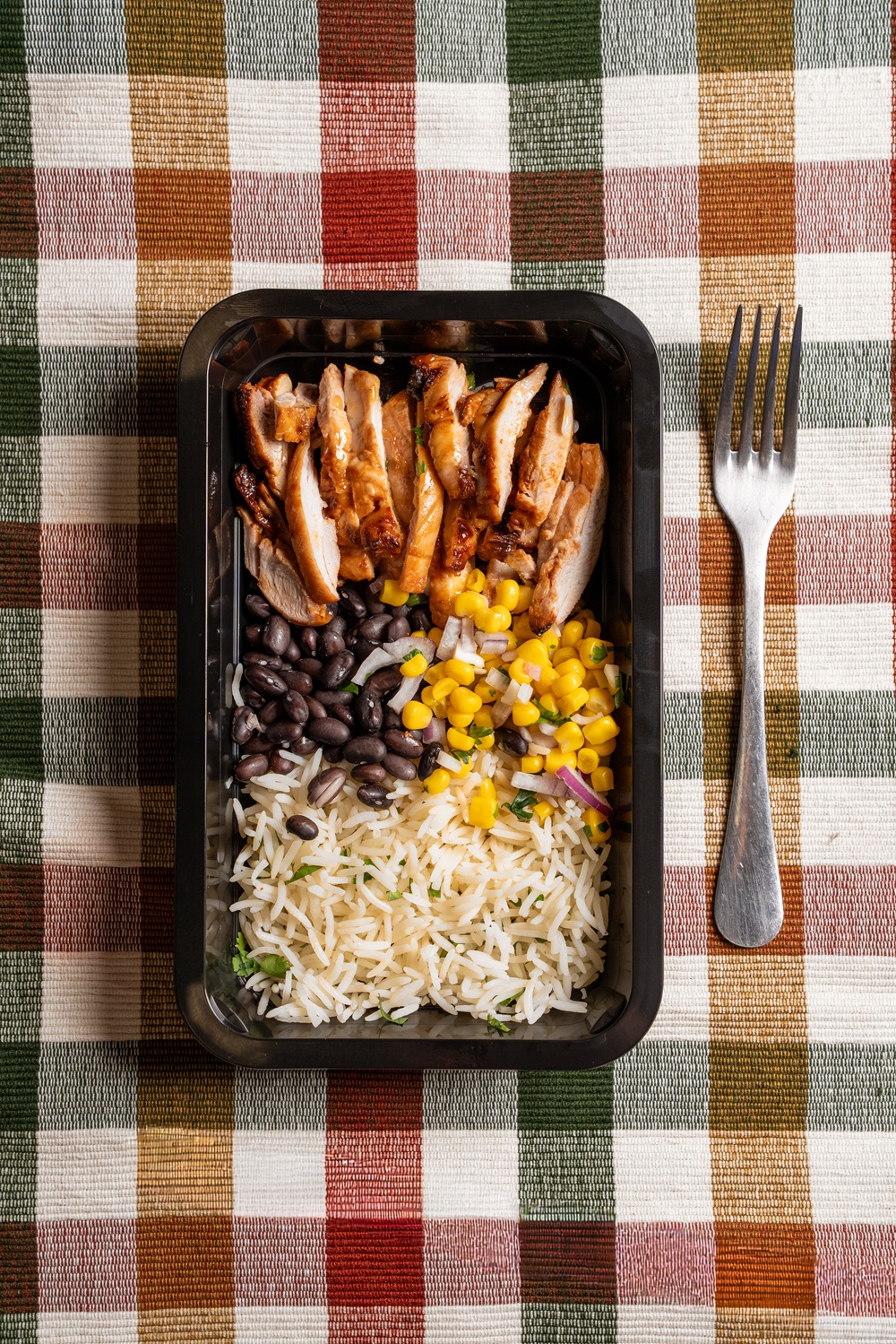 Healthy prepared meal prep tray with rice, beans and chicken