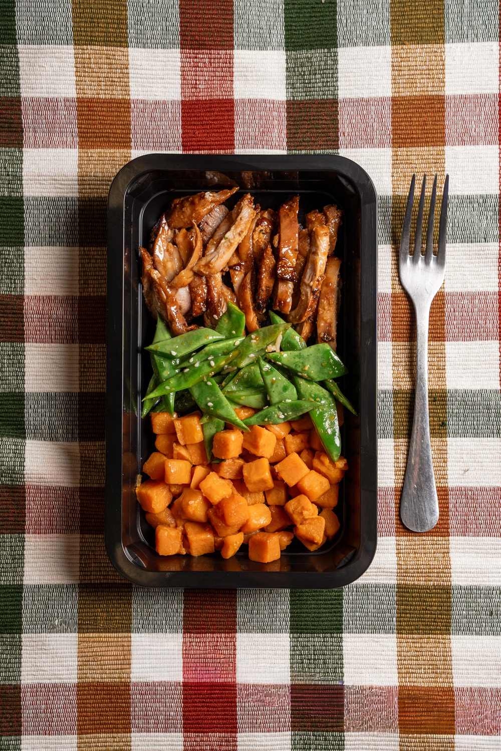 High protein meal prep tray with chicken, vegetables and sweet potato